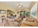Inviting living room boasts a ceiling fan, comfortable seating, and sliding glass doors to an outdoor space at 121 Auburn Woods Cir, Venice, FL 34292