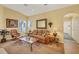Comfortable living room with a ceiling fan, plush seating, and a view of the entryway at 121 Auburn Woods Cir, Venice, FL 34292