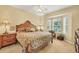 Cozy main bedroom featuring a wooden bed frame and bay window for natural light at 121 Auburn Woods Cir, Venice, FL 34292