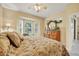 Main bedroom with a large wooden dresser and bay window letting in natural light at 121 Auburn Woods Cir, Venice, FL 34292