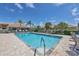 Community pool offers clear blue water and lounge chairs for residents to enjoy in a beautiful outdoor setting at 121 Auburn Woods Cir, Venice, FL 34292