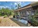 Charming screened-in patio area with views of the beautifully landscaped backyard and garden at 1281 Wilson Dr, Englewood, FL 34224