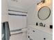 Bright bathroom with white shiplap walls, patterned tile flooring, and modern vanity at 1281 Wilson Dr, Englewood, FL 34224