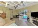 Spacious bonus room featuring comfortable seating and a view of the pool through sliding glass doors at 1281 Wilson Dr, Englewood, FL 34224