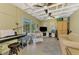 Bonus room with a keyboard, seating, TV and slider doors to the back, offering a versatile space at 1281 Wilson Dr, Englewood, FL 34224
