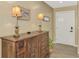Inviting entryway with a wooden console table, lamps, decor, and a secure front door at 1281 Wilson Dr, Englewood, FL 34224
