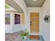 Inviting front entrance with a decorative front door, attractive light fixture and well-kept landscaping at 1281 Wilson Dr, Englewood, FL 34224