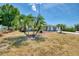 Charming single-story home with lush, tropical landscaping in the front yard with a long driveway at 1281 Wilson Dr, Englewood, FL 34224