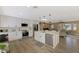 Open concept kitchen with a large island, stainless steel appliances, modern white cabinets, and a view of the living area at 1281 Wilson Dr, Englewood, FL 34224