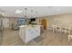 Kitchen featuring island with eat-in seating, stainless appliances, and open floor plan to the living and dining areas at 1281 Wilson Dr, Englewood, FL 34224