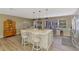 Bright kitchen with modern island, stainless steel appliances, and an open floor plan that joins dining and outdoor views at 1281 Wilson Dr, Englewood, FL 34224