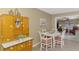 Eat-in kitchen displays vintage cabinet and breakfast nook with charming furniture at 1281 Wilson Dr, Englewood, FL 34224