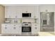 Modern kitchen with stainless steel appliances, white cabinets, and sleek countertops at 1281 Wilson Dr, Englewood, FL 34224