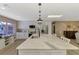 Well-lit kitchen with island, stainless appliances, white cabinetry, and eat-in bar overlooking the pool area at 1281 Wilson Dr, Englewood, FL 34224