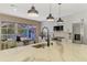 Bright kitchen features a large island with views of pool, stainless appliances, and white cabinets at 1281 Wilson Dr, Englewood, FL 34224