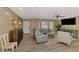 Cozy living room with wood floors, a large bay window, and stylish furnishings for comfortable living at 1281 Wilson Dr, Englewood, FL 34224