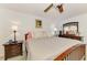 Comfortable bedroom features plush bedding, ceiling fan, and wood furniture at 1281 Wilson Dr, Englewood, FL 34224