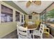 Enclosed patio area with a wooden table set, offering a comfortable and shaded outdoor dining space at 1281 Wilson Dr, Englewood, FL 34224