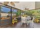 Screened-in patio dining area with a decorative garden providing a lovely outdoor space at 1281 Wilson Dr, Englewood, FL 34224