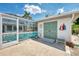 Outdoor pool area featuring a screened-in pool, storage shed and well-maintained concrete patio at 1281 Wilson Dr, Englewood, FL 34224
