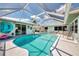 Inviting screened pool with clear blue water, lounge chairs, and a bright, airy feel at 1281 Wilson Dr, Englewood, FL 34224