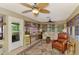 Cozy sunroom with comfortable seating, ceiling fans, and large windows offering natural light at 1281 Wilson Dr, Englewood, FL 34224