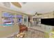 Bright sunroom with a view of the pool, seamless transition to the living area and kitchen at 1281 Wilson Dr, Englewood, FL 34224