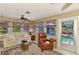 Inviting sunroom featuring comfortable seating, a ceiling fan, and a view of the pool at 1281 Wilson Dr, Englewood, FL 34224