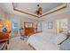 Bedroom featuring a wood bed frame, neutral walls, wood ceiling accents, and a rocking chair at 13215 Amerigo Ln, Venice, FL 34293