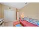 Bedroom featuring a daybed with colorful pillows, neutral walls, and a closet at 13215 Amerigo Ln, Venice, FL 34293