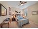 Bedroom featuring a Queen bed, neutral walls, and tropical decor at 13215 Amerigo Ln, Venice, FL 34293