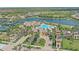 Community clubhouse featuring resort-style amenities, lush landscaping, and a serene lakeside setting at 13215 Amerigo Ln, Venice, FL 34293