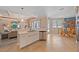 Modern eat-in kitchen with stainless steel appliances and a large island with views of the living area at 13215 Amerigo Ln, Venice, FL 34293