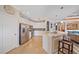 Modern kitchen with white cabinets, stainless steel appliances, and a breakfast bar at 13215 Amerigo Ln, Venice, FL 34293