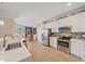 Bright kitchen with white cabinetry, stainless steel appliances, and decorative backsplash at 13215 Amerigo Ln, Venice, FL 34293