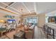 Bright living room with views of the pool and lake and access to the kitchen at 13215 Amerigo Ln, Venice, FL 34293