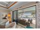 Covered patio showcasing comfortable seating and sliding glass doors to the living room at 13215 Amerigo Ln, Venice, FL 34293