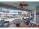 Relaxing covered patio with comfortable seating and views of the pool and lake, a perfect retreat at 13215 Amerigo Ln, Venice, FL 34293