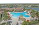 Resort-style community pool featuring a unique design, ample seating, and lush landscaping at 13215 Amerigo Ln, Venice, FL 34293