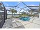 Sparkling private pool overlooking a serene lake, surrounded by lush landscaping and lounge chairs at 13215 Amerigo Ln, Venice, FL 34293
