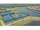 Community tennis and pickleball courts nestled beside a serene lake and walking paths at 13215 Amerigo Ln, Venice, FL 34293