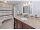 Classic bathroom design with granite countertops, a dark vanity, and a shower-tub combination at 1340 Olympia Rd, Venice, FL 34293