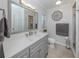 Modern bathroom features a gray vanity with clean white countertops and updated fixtures at 1340 Olympia Rd, Venice, FL 34293
