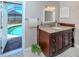 Elegant bathroom with a granite vanity, decorative fixtures, and direct access to the pool area at 1340 Olympia Rd, Venice, FL 34293