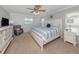 Comfortable bedroom featuring stylish decor, a ceiling fan, and natural light from the windows at 1340 Olympia Rd, Venice, FL 34293