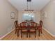 Traditional dining room with hardwood floors, a wooden table and a decorative light fixture at 1340 Olympia Rd, Venice, FL 34293