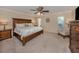 Spacious main bedroom with a ceiling fan, carpeted floor, and stylish furnishings at 1340 Olympia Rd, Venice, FL 34293