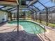Inviting screened-in pool with brick pavers, and metal steps at 1340 Olympia Rd, Venice, FL 34293