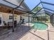 The covered patio is perfect for relaxing by the pool, with ample seating and serene backyard views at 1340 Olympia Rd, Venice, FL 34293