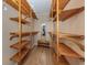 A large walk-in closet with shelving on both sides provides ample space for clothes and shoes at 1340 Olympia Rd, Venice, FL 34293